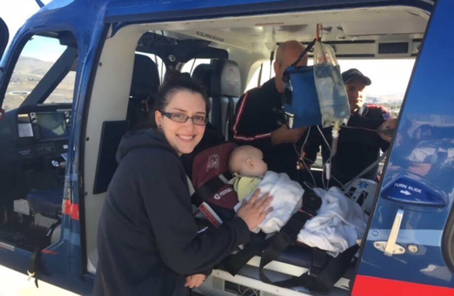 Eric comforts baby Son as he's loaded into a helicopter for transport to another hospital