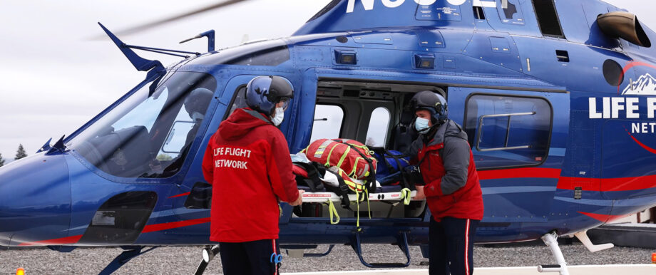 Two flight nurses load a patient into a helicopter