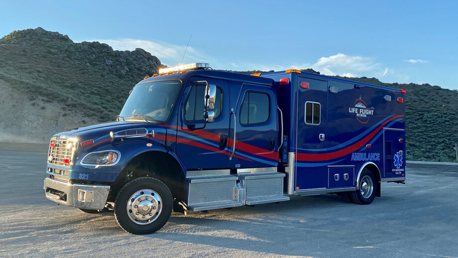 Heavy duty-looking ambulance with high-desert in background