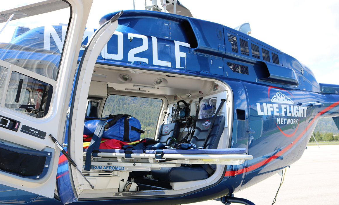 Patient bar doors are open to Bell 407GXi Helicopter showing and extended gurney